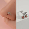 Silver surgical steel demon angel nose studs with orange-red gemstone accents