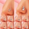 A collection of surgical steel demon angel nose studs in various designs and finishes shown on a skin model.