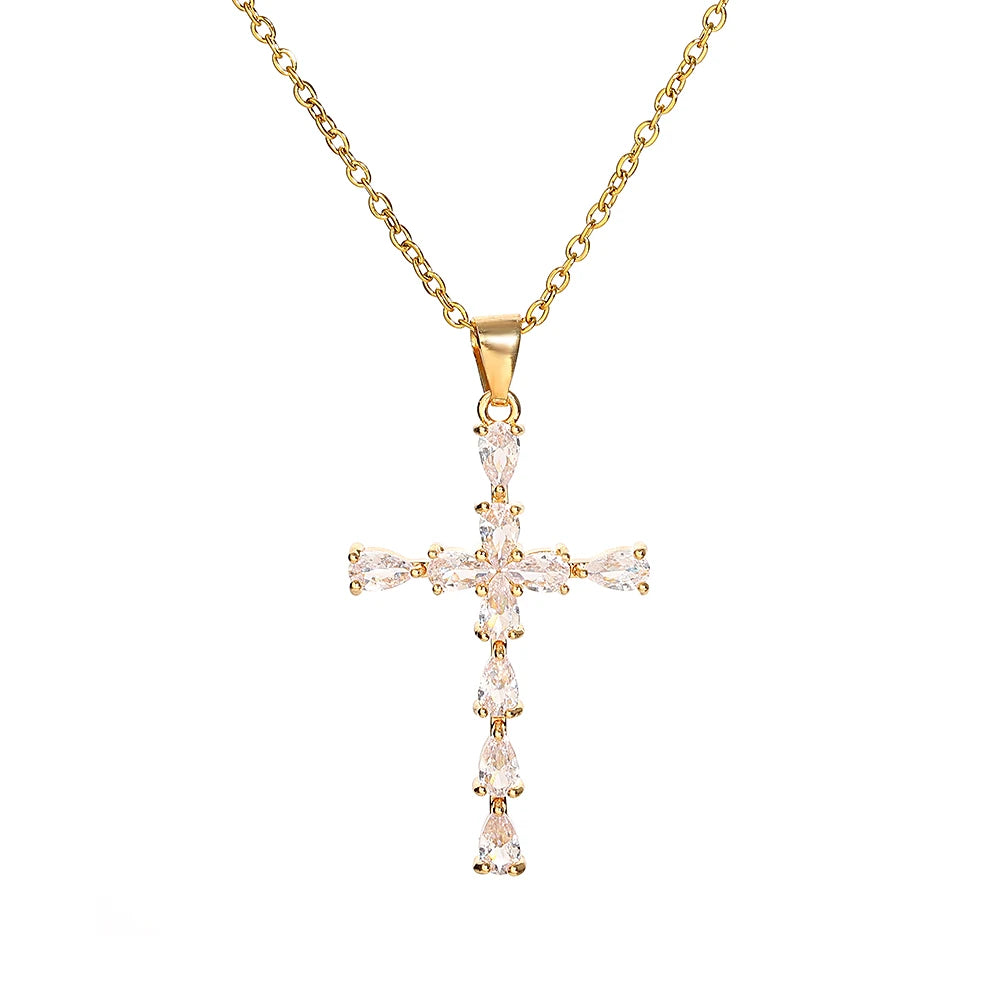 A delicate gold-toned stainless steel cross necklace with a detailed, pave-set design.