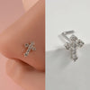 Silver surgical steel demon angel nose studs shown on a pink ear, detailed close-up view.