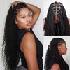 A woman models long black kinky straight human hair extensions styled in boho braids.