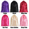 A set of five satin drawstring storage pouches in purple, black, wine red, hot pink, rose gold, and deep pink.