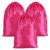 A set of three bright pink satin drawstring storage pouches.