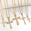 A collection of gold-toned stainless steel cross necklaces displayed on a white background.