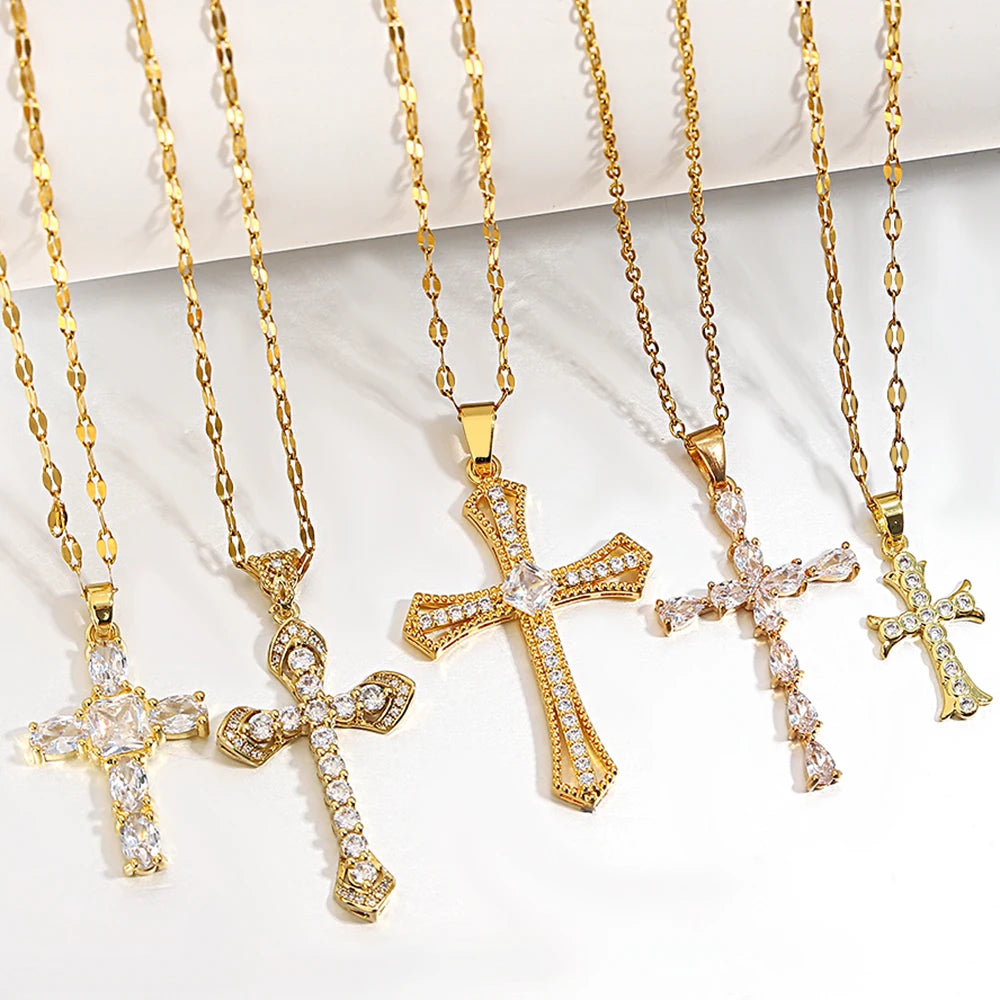 A collection of gold-toned stainless steel cross necklaces displayed on a white background.
