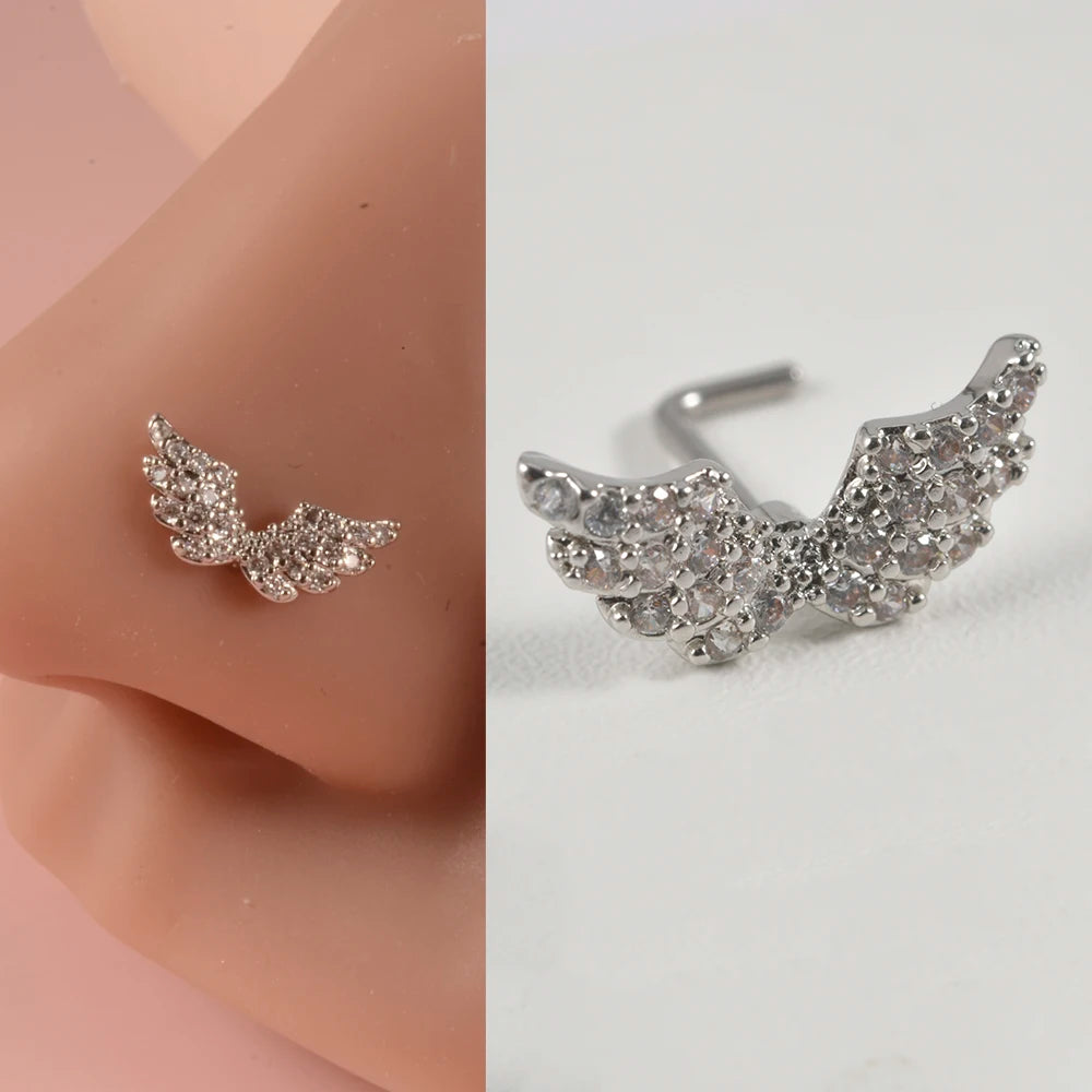 Silver surgical steel demon angel nose studs with a detailed, sparkling wing design