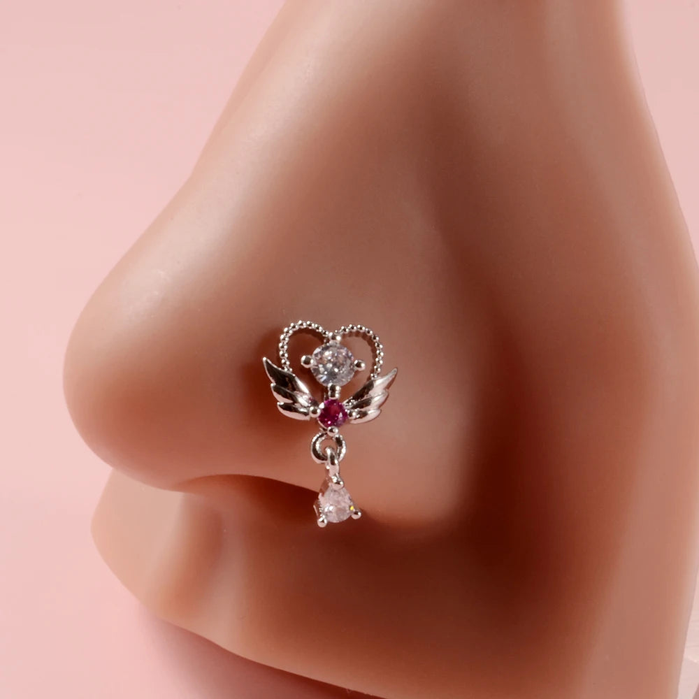 Silver demon angel nose studs featuring a central diamond and a teardrop-shaped stone.