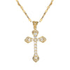 A gold stainless steel cross necklace with a detailed design and small diamonds.