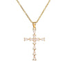 A delicate gold-toned stainless steel cross necklace with small clear stones.