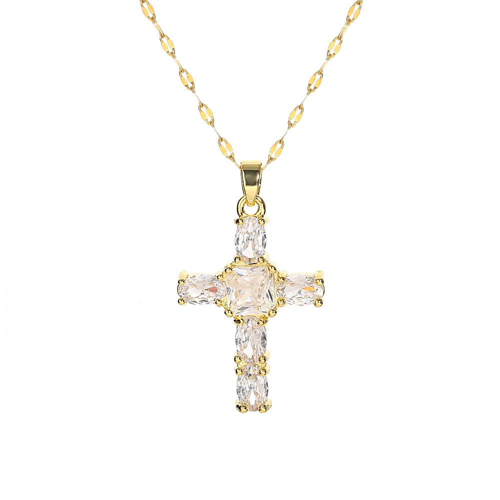 A gold-toned stainless steel cross necklace featuring clear cubic zirconia stones.