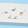 A collection of surgical steel demon angel nose studs in various silver and gold finishes.