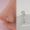 Silver surgical steel demon angel nose studs with a dangling orange gemstone.