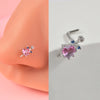 Silver surgical steel demon angel nose studs featuring a pink gemstone and blue accents
