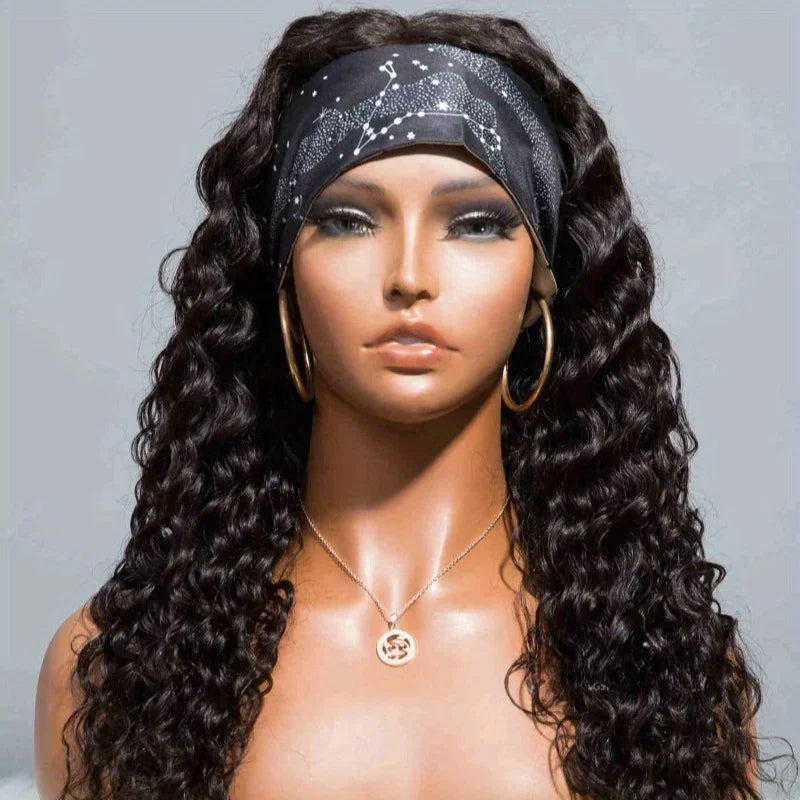 A model wears a black glitter headband and long, dark curly hair with gold hoop earrings.