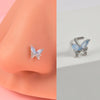 Silver butterfly nose studs with iridescent blue and silver accents