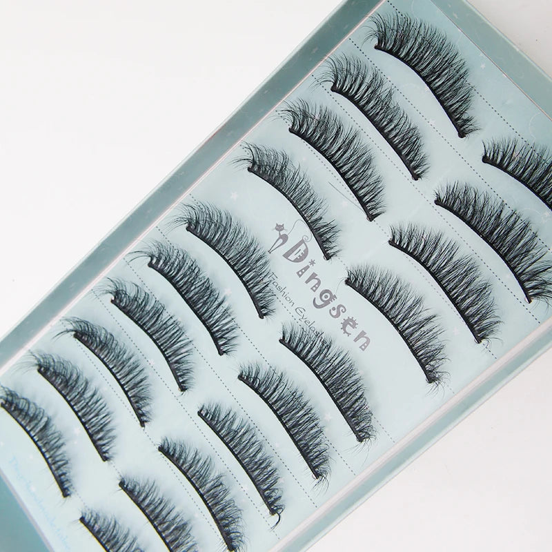 A tray of black mink false eyelashes displayed on a light blue background.