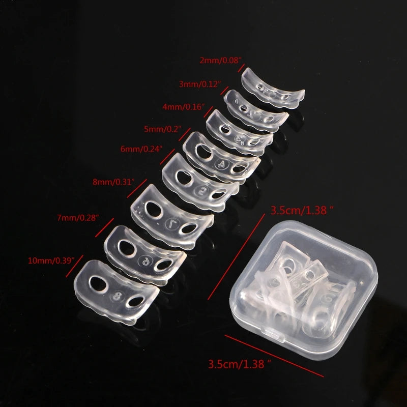 A set of silicone ring size adjusters shown with various sizes arranged in a line and a separate molded plastic container.
