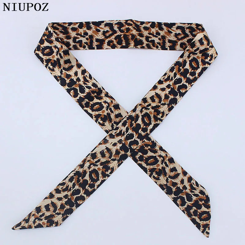 A black and brown leopard print silk headband or scarf tied in an 'X' shape.