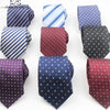A collection of men's neckties featuring various patterns including stripes, dots, and solids in blue, purple, and black.