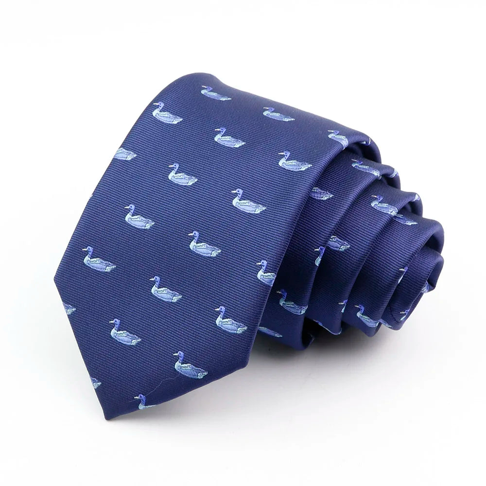 Corbata de seda jacquard azul marino con patrón repetitivo de patitos blancos pequeños.
