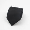 Black necktie with a subtle stripe pattern folded neatly.