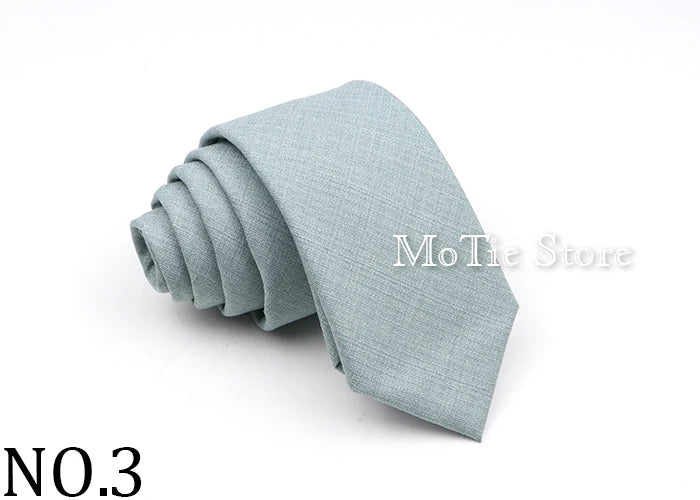 A light blue solid color anti-wrinkle bamboo fiber tie folded neatly.