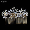 A delicate silver rhinestone bridal hair comb tiara with leafy accents and dangling strands.