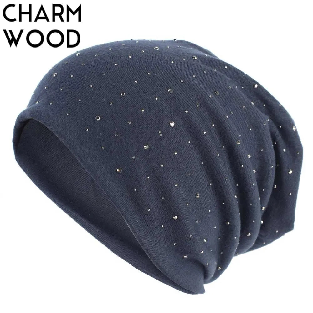 A dark blue knitted beanie hat decorated with small silver rhinestones.