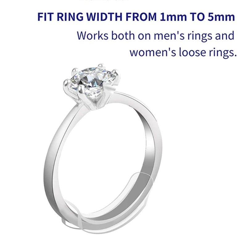 A close-up view of a silver-toned ring with a clear diamond solitaire setting.