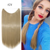 A woman shows off long, straight blonde hair extensions styled in a braid against a blue background.