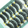 A display of black and gold handmade 3D mink false eyelashes on a light green background.