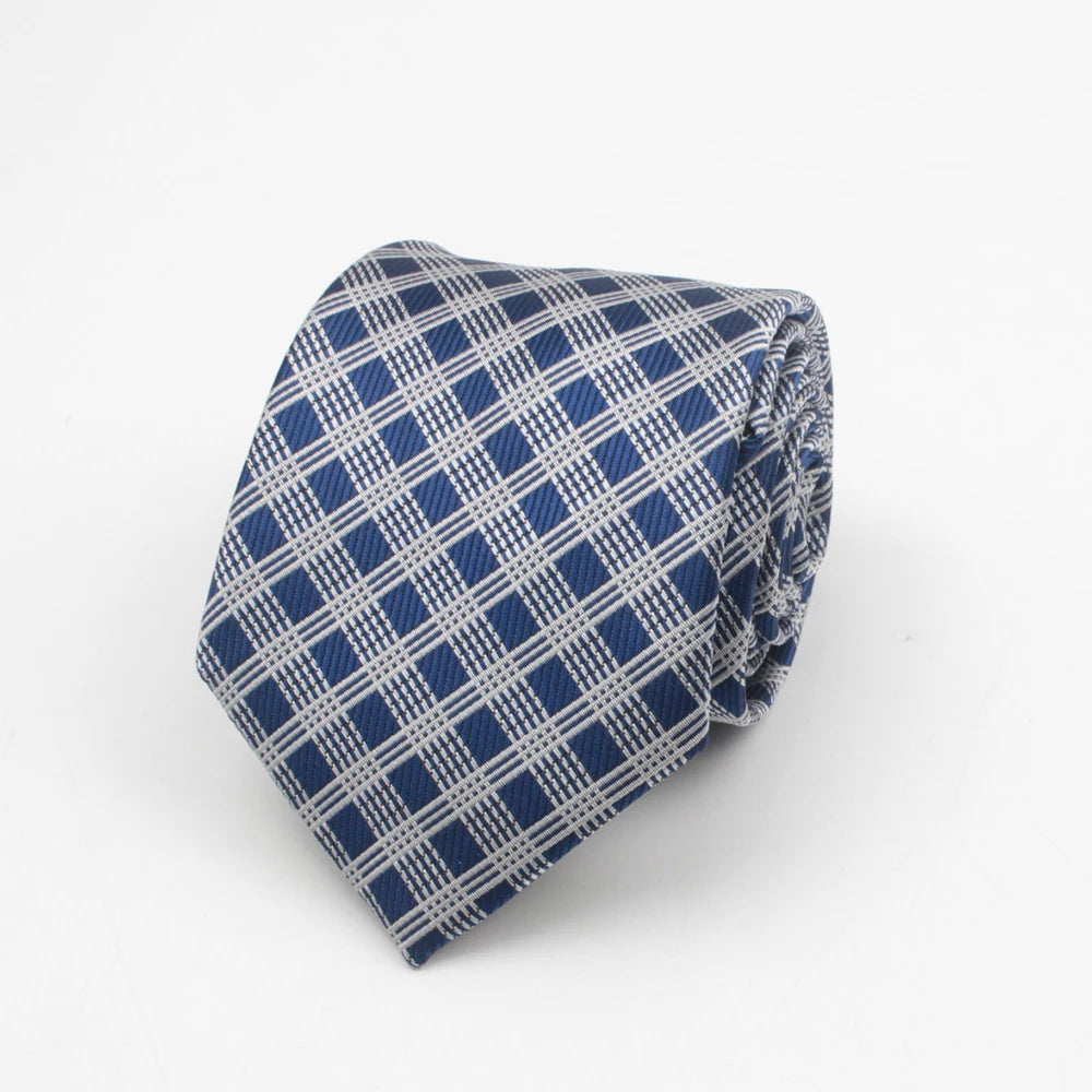A folded blue and white patterned necktie with a geometric stripe and dot design.