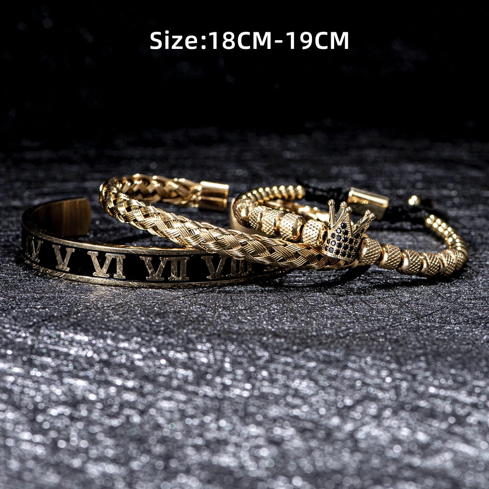 Pulseras de esmalte dorado y negro con números romanos sobre una superficie oscura.