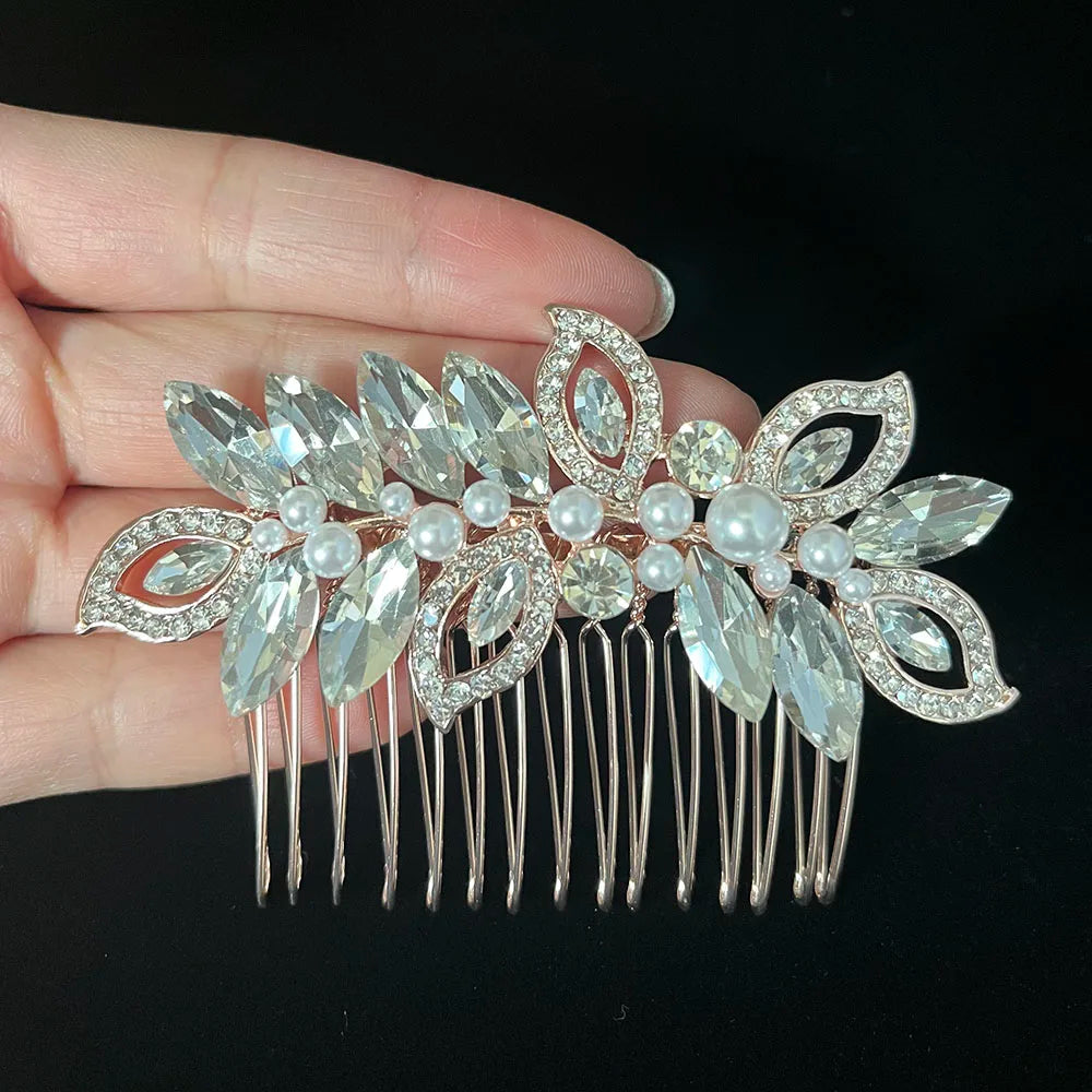 A silver rhinestone bridal hair comb featuring delicate floral designs and pearl accents.