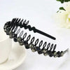 Black rhinestone anti-slip hairband for women displayed on a white surface.