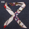 A multi-color leopard print silk headband scarf tied in an 'X' shape.