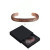 A copper magnetic bangle with a plum flower design shown next to its black presentation box.