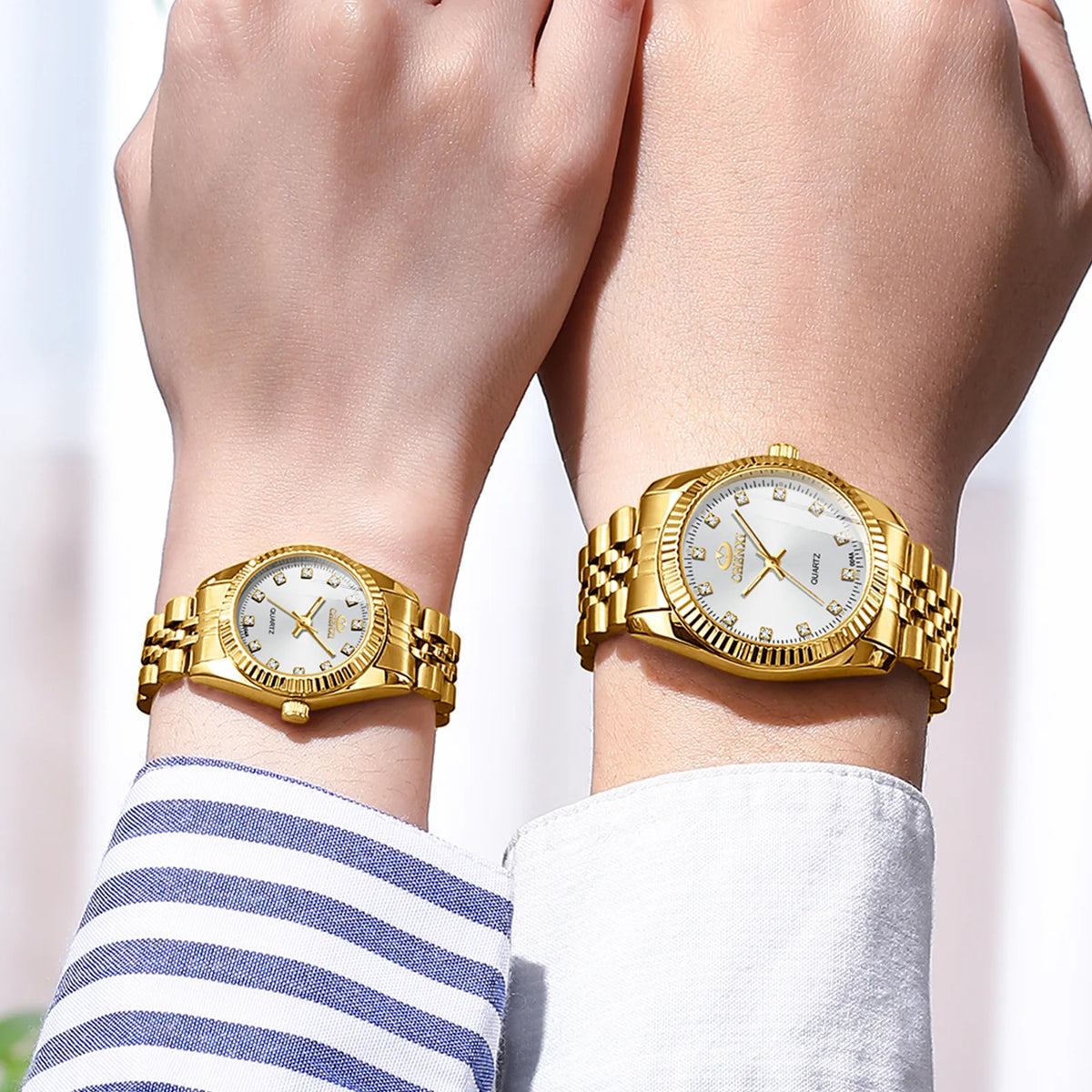 A close-up of a luxury golden quartz wristwatch worn on a wrist, featuring a gold-toned case and bracelet.