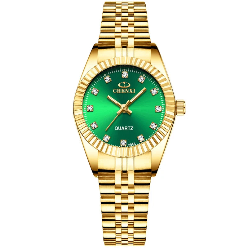 A gold-toned wristwatch with a green face and gold accents, featuring a textured metal band.