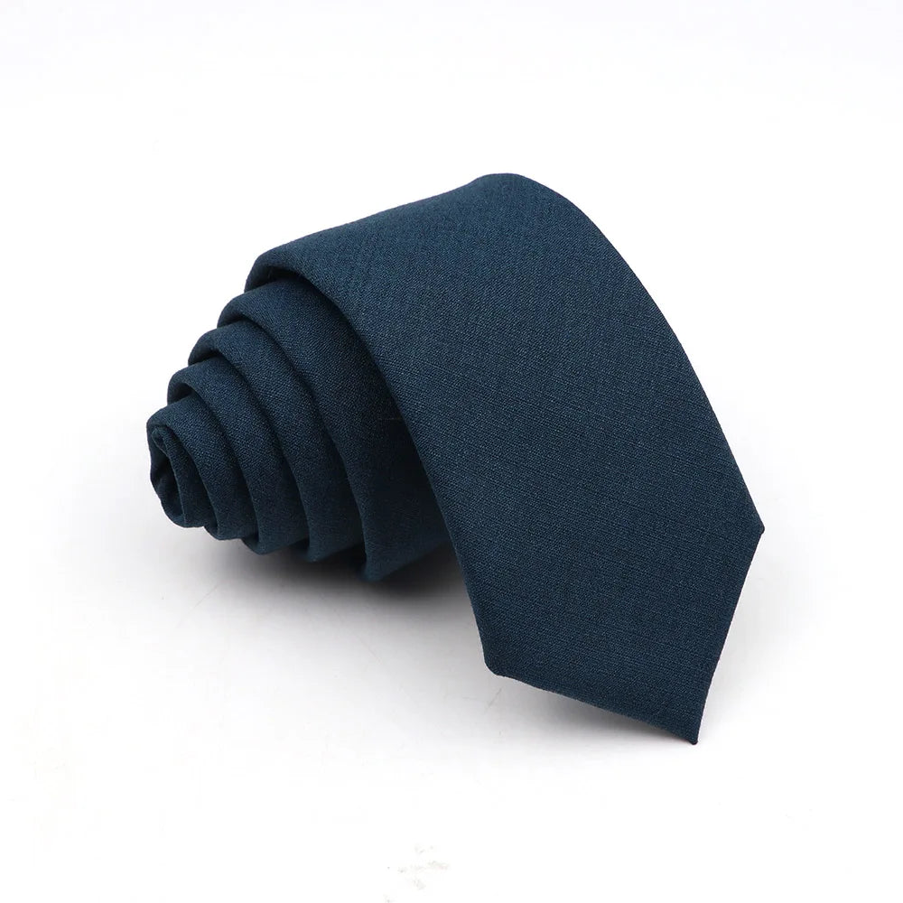 A dark navy blue anti-wrinkle bamboo fiber necktie folded neatly on a white background.