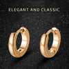 Pair of elegant gold hoop earrings displayed against a dark, sparkling background.