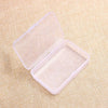 A clear plastic container with a lid is shown open on a beige fabric background.