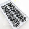 A tray of dramatic mink false eyelashes with varying lengths and styles displayed on a white background.
