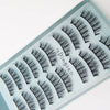 A display of black mink false eyelashes arranged in rows on a light blue tray.