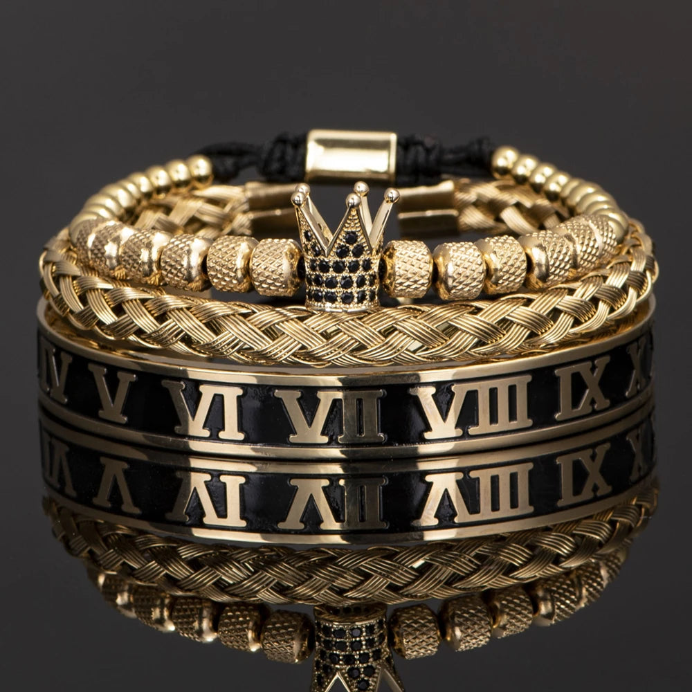 Pulseras de esmalte doradas y negras con números romanos apilados sobre una superficie reflectante.