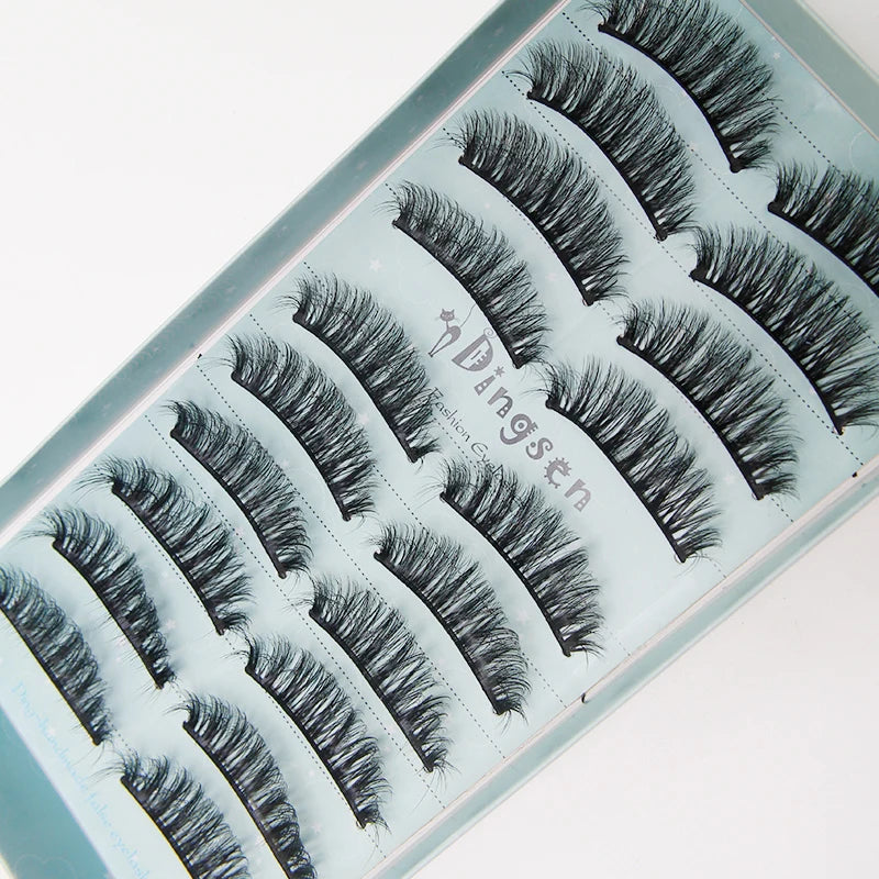 A display of various styles of black mink false eyelashes on a light blue packaging tray.