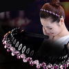 A woman is wearing a black pearl rhinestone anti-slip headband on her hair.