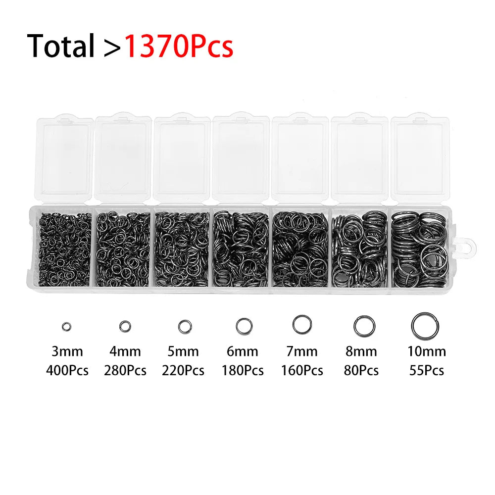 A collection of black jewelry findings including various sizes of rings and jump rings packaged in clear compartments.