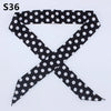 Black and white polka dot fabric ribbon shaped like an 'X'