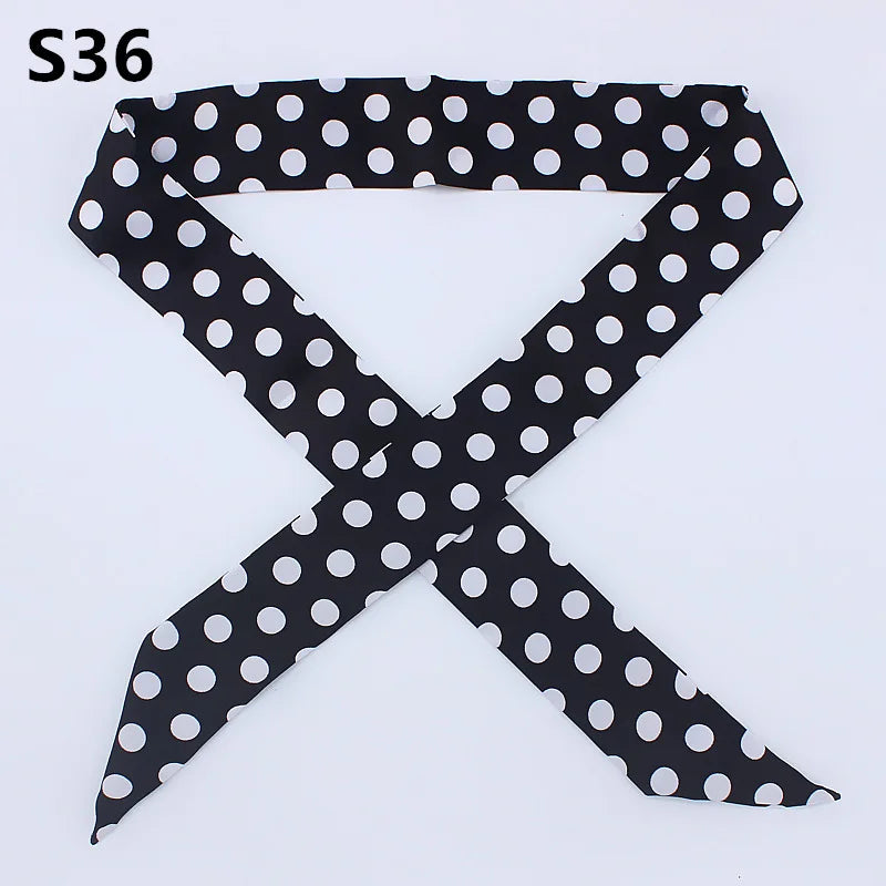 Black and white polka dot fabric ribbon shaped like an 'X'